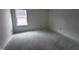 Simple bedroom with a window and unfinished flooring at 3284 Roundly Rd # 16, New Hill, NC 27562