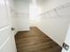 Spacious walk-in closet with ample shelving and wood floors, providing plenty of storage at 3284 Roundly Rd # 16, New Hill, NC 27562