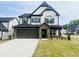 Charming two-story home boasts a stone-accented entrance and a two-car garage at 3284 Roundly Rd # 16, New Hill, NC 27562