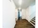 Long hallway with wood-look flooring, white walls, and a staircase leading to the upper level at 3284 Roundly Rd # 16, New Hill, NC 27562