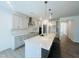 A bright kitchen featuring a large island, stainless appliances, tile backsplash, and gray cabinets at 3284 Roundly Rd # 16, New Hill, NC 27562