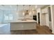 Bright kitchen features a large island, stainless appliances, pendant lighting, and gray cabinets at 3284 Roundly Rd # 16, New Hill, NC 27562