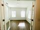 Bright office space with two large windows and wood-look flooring, perfect for working from home at 3284 Roundly Rd # 16, New Hill, NC 27562