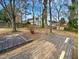 Large backyard with wooden deck and mature trees at 3321 Beech Bluff Ln, Raleigh, NC 27616