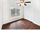 Bright bedroom with hardwood floors, double closets, and a large window at 3321 Beech Bluff Ln, Raleigh, NC 27616