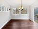Sunlit dining area with hardwood floors and chandelier at 3321 Beech Bluff Ln, Raleigh, NC 27616