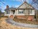 Brick and siding ranch home with a landscaped yard and walkway at 3321 Beech Bluff Ln, Raleigh, NC 27616