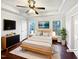 Virtually staged bedroom with hardwood floors and ceiling fan at 3321 Beech Bluff Ln, Raleigh, NC 27616