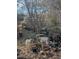 Overgrown backyard with numerous plant pots at 4053 Little Creek Church Rd, Clayton, NC 27520