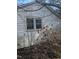 White house exterior with two windows and overgrown bushes at 4053 Little Creek Church Rd, Clayton, NC 27520