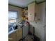 View of a cluttered kitchen with cabinets and appliances at 4053 Little Creek Church Rd, Clayton, NC 27520