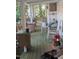Wooden porch with rocking chairs and various items at 4053 Little Creek Church Rd, Clayton, NC 27520