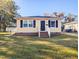 Charming yellow house with a neat lawn and white steps at 509 Mullins St, Rocky Mount, NC 27803