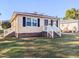 Cute yellow house with white steps and a well-maintained lawn at 509 Mullins St, Rocky Mount, NC 27803