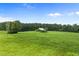 Large grassy field with a dilapidated shed in the background at 5306 Nc 54 Highway, Chapel Hill, NC 27516