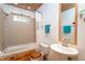 Clean bathroom with a bathtub, shower, and pedestal sink at 6328 Bissette Rd, Wendell, NC 27591