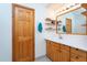 Bathroom boasts wood cabinets and updated vanity at 6328 Bissette Rd, Wendell, NC 27591