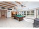 Spacious game room with pool table, wood beams, and a wood-burning stove at 6328 Bissette Rd, Wendell, NC 27591