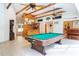 Game room with pool table, wood bar, and wood-beamed ceiling at 6328 Bissette Rd, Wendell, NC 27591