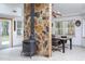 Game room with stone wall, wood stove, and a pool table at 6328 Bissette Rd, Wendell, NC 27591