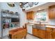 Bright kitchen with stainless steel sink, wood cabinets, and ample counter space at 6328 Bissette Rd, Wendell, NC 27591