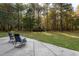 Concrete patio with chairs, surrounded by trees at 6328 Bissette Rd, Wendell, NC 27591
