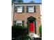 Brick townhouse with red front door, green shutters, and landscaping at 6369 New Market Way, Raleigh, NC 27615