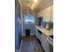 White kitchen cabinets, laminate flooring, and a chalkboard accent wall at 6369 New Market Way, Raleigh, NC 27615
