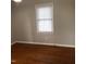 Bright bedroom with hardwood floors and a window at 7317 Bentley Wood Ln, Raleigh, NC 27616