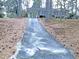 Charming single story home with mature trees, brick accents, and a long driveway at 7317 Bentley Wood Ln, Raleigh, NC 27616