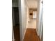 Hallway with hardwood flooring and views of the kitchen area with stainless steel refrigerator at 7317 Bentley Wood Ln, Raleigh, NC 27616