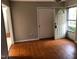 Living room with hardwood floors and exterior door at 7317 Bentley Wood Ln, Raleigh, NC 27616