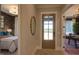 Entryway with wood door, mirror, and view into bedroom and office at 82 Byrd Ln, Pittsboro, NC 27312