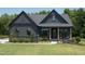 Craftsman style home with dark siding, light trim, and a covered porch at 82 Byrd Ln, Pittsboro, NC 27312