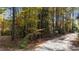Wooded lot with gravel driveway and community sign at 82 Byrd Ln, Pittsboro, NC 27312