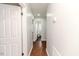 Clean hallway with hardwood floors leading to bathroom at 902 Cobb Ct, Sanford, NC 27330