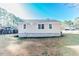 Tan house exterior with vinyl siding, several windows, and a grassy yard at 902 Cobb Ct, Sanford, NC 27330