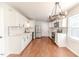 Modern kitchen with white cabinets, stainless steel appliances, and marble backsplash at 902 Cobb Ct, Sanford, NC 27330
