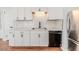 White shaker cabinets, marble backsplash, and stainless steel appliances in this kitchen at 902 Cobb Ct, Sanford, NC 27330