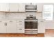 Stainless steel range, microwave, and white shaker cabinets in this kitchen at 902 Cobb Ct, Sanford, NC 27330