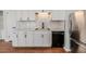 White shaker cabinets, marble backsplash, and stainless steel appliances in this kitchen at 902 Cobb Ct, Sanford, NC 27330