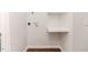 Bright laundry room with built-in shelving and vinyl flooring at 902 Cobb Ct, Sanford, NC 27330