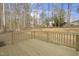 Wood deck in a backyard, surrounded by tall trees, offering a private and serene outdoor space at 100 Sequoia Dr # 2387, Louisburg, NC 27549