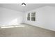 Bright bedroom with carpet, a double window providing ample natural light and a white door at 100 Sequoia Dr # 2387, Louisburg, NC 27549
