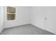 Bright, carpeted bedroom with large window and neutral color scheme at 100 Sequoia Dr # 2387, Louisburg, NC 27549
