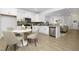 Bright kitchen with white cabinets, stainless steel appliances, gray backsplash, and an adjacent dining area with seating for four at 100 Sequoia Dr # 2387, Louisburg, NC 27549