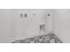 Well lit laundry room with a stylish black and white patterned floor and washer/dryer hookups at 100 Sequoia Dr # 2387, Louisburg, NC 27549