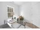 Bright office featuring a modern glass desk, plush rug, and serene window view at 100 Sequoia Dr # 2387, Louisburg, NC 27549