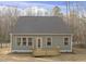 Rear exterior showcasing the light gray siding, gray roof, wood deck, and multiple windows at 100 Sequoia Dr # 2387, Louisburg, NC 27549