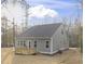 The rear exterior shows a home with a new deck and gray siding, surrounded by a partially wooded area at 100 Sequoia Dr # 2387, Louisburg, NC 27549
